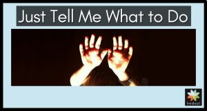 A child's hands are raised up and lit up against a dark backdrop. You can barely see the top of a head and a bracelet on one wrist. The words over the image are "Just Tell Me What to Do". The Keduzi logo, which is a colourful flower, is also over the image.
